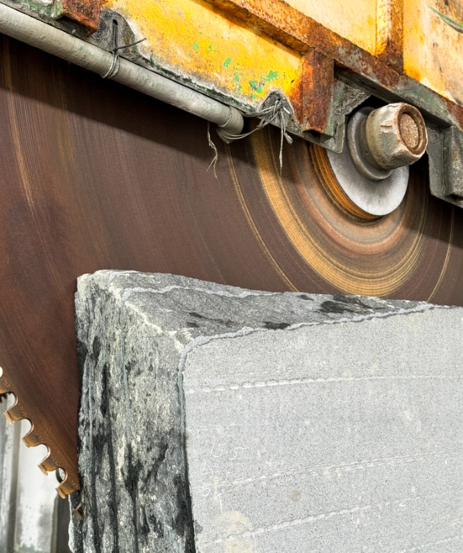 Hydralic saw cutting granite.