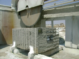 Granite slabs being polished on industrial polishing machine
